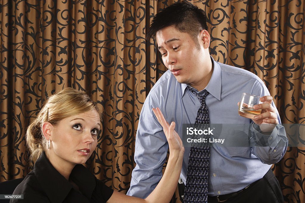 A drunk man tries to make advances on a woman as she tells him NO. Image from iStock | Lisay